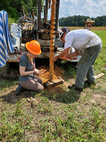 Geologists examining drill cuttings from Pliocene-age sand
